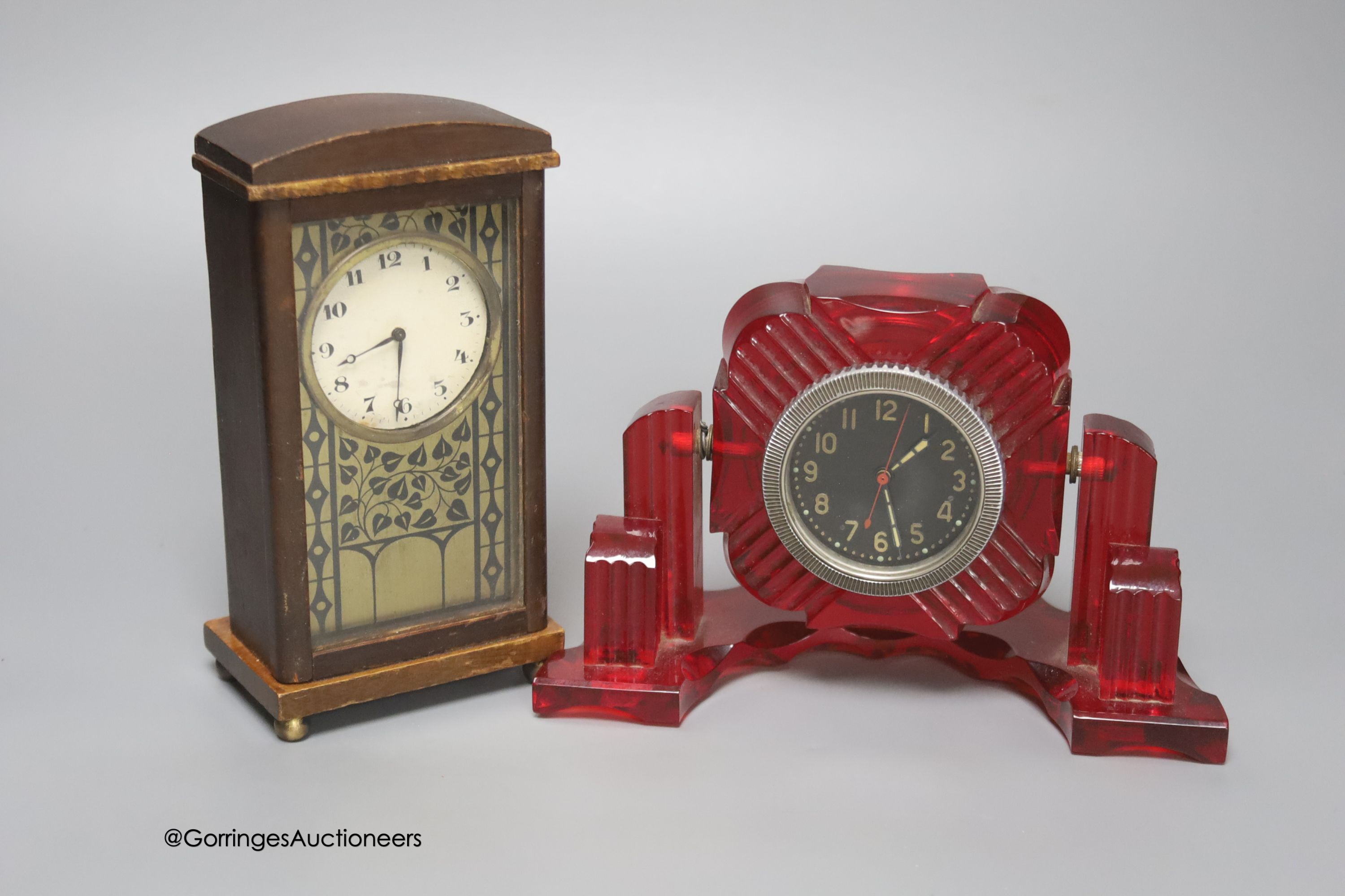 A Russian moulded red acrylic mantel timepiece, width 19cm, and a Secessionist style beech cased timepiece